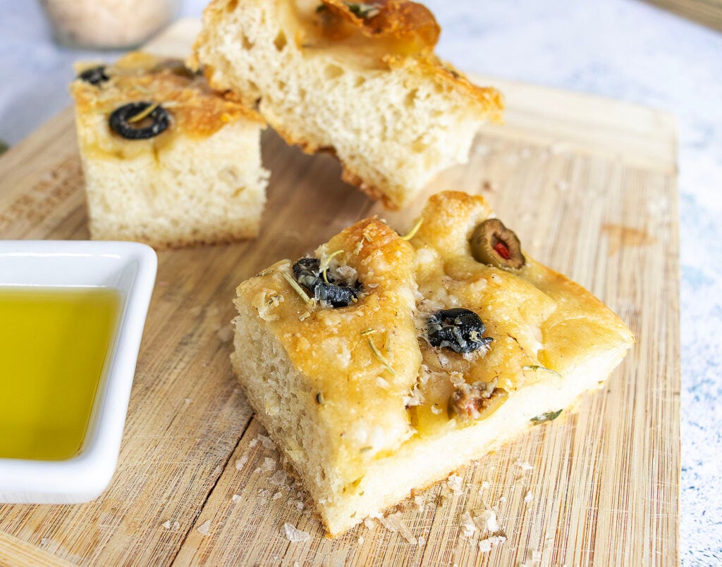 Olive Focaccia with olive oil on a wooden board