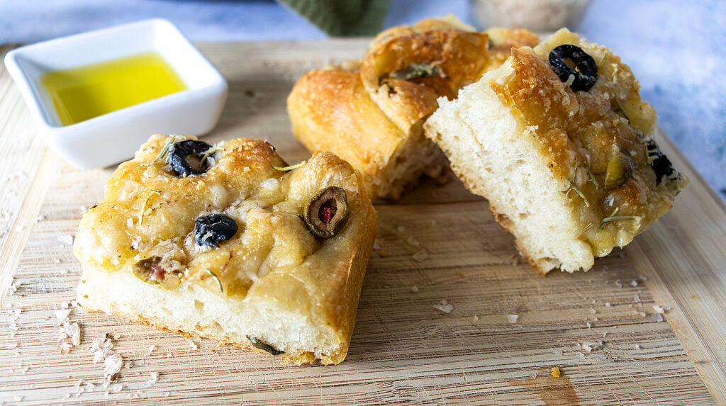 Asiago Focaccia with olive oil on a wooden board